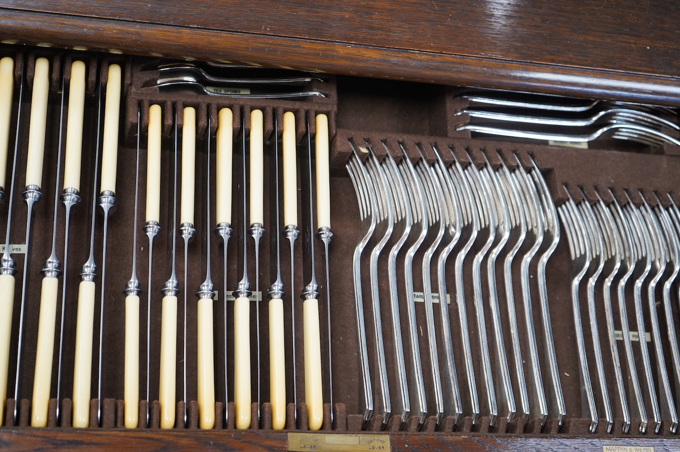 A Mappin and Webb oak Jacobean style canteen of plated flatware, complete contents, containing twelve settings, etc. Condition - fair to good